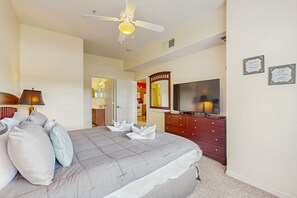 A bedroom with a bed, a dresser, a television, and a ceiling fan. - Spacious Townhouse With Resort Style Amenities, Waterview and Fitness Center (Kissimmee)
