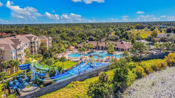 A resort with multiple swimming pools, a water park, and a large building with balconies. - Friendly Condo With Pool and hot tub Access, Wifi, Central AC, and Private W/D (Kissimmee)