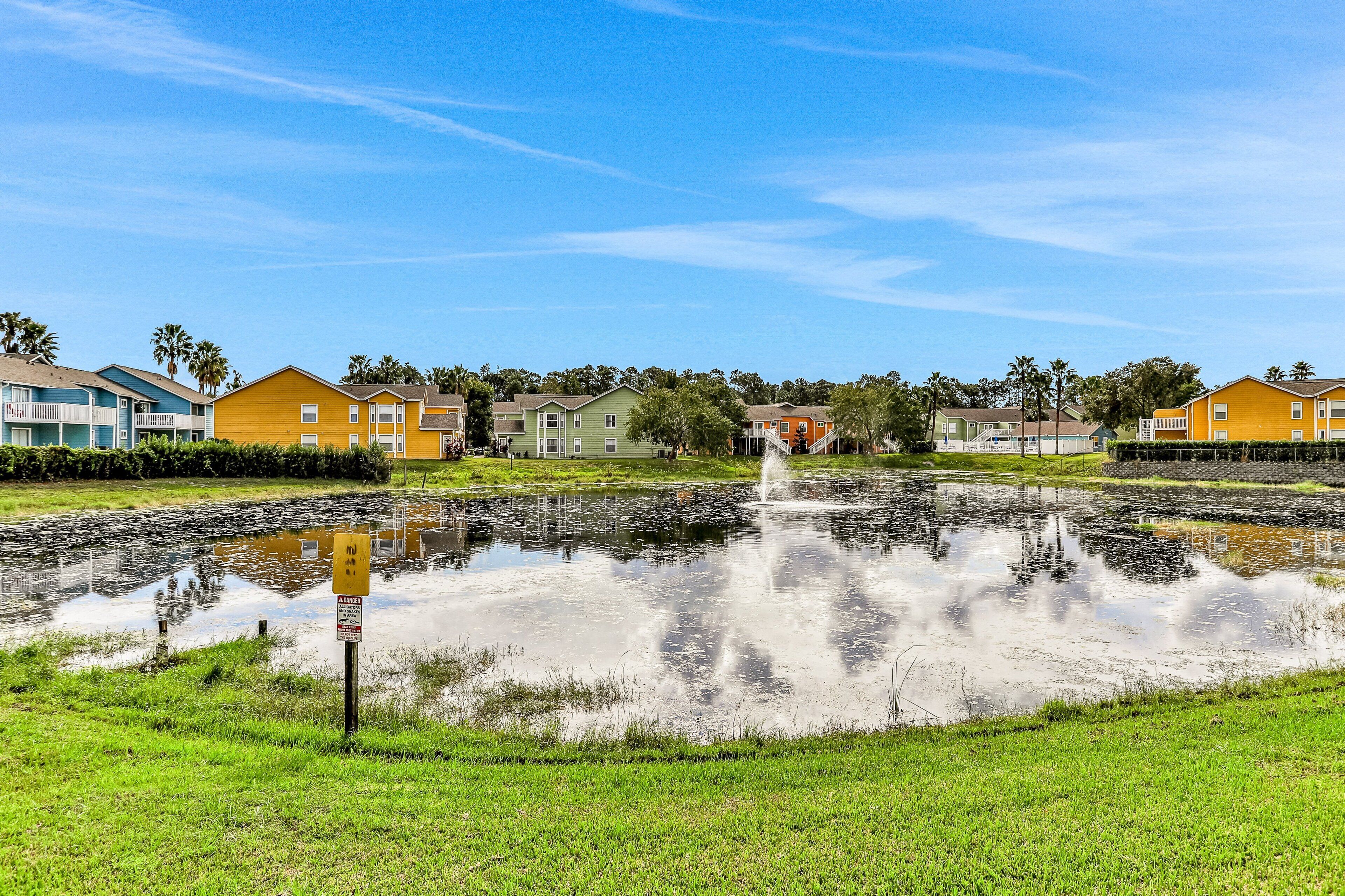 Zona residencial con casas, un estanque y una fuente.