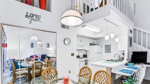A modern interior with a dining area, kitchen, and living space. - Breezy Townhouse With a Pool, hot Tub, Patio, Central AC, and Washer/dryer (Kissimmee)