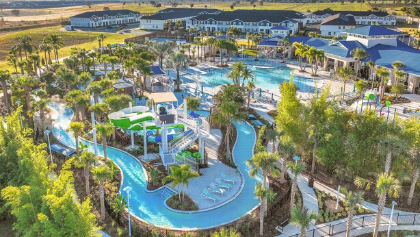 A resort with a large swimming pool, water slides, and multiple guest buildings. - Spacious Resort Home With Private Pool, Game Room, & Abundant Amenities (Davenport)