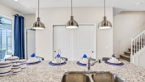 A kitchen with a double sink, stainless steel appliances, and pendant lighting. - Spacious Resort Home With Private Pool, Game Room, & Abundant Amenities (Davenport)
