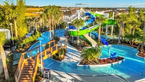 A pool area with a water slide, lounge chairs, and a staircase leading to a pool deck. - Inviting Family-friendly Home W/private Pool, Spa, Central AC, & W/D (Davenport)