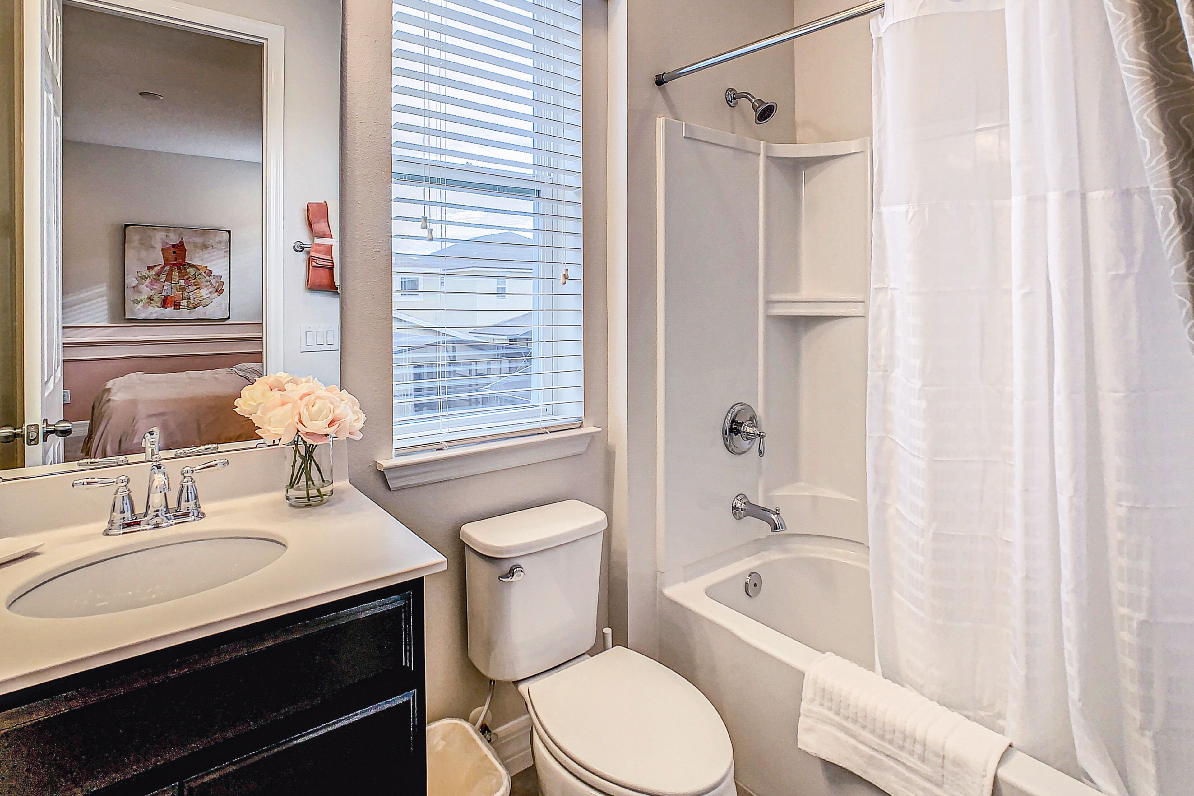A bathroom with a sink, toilet, and bathtub.