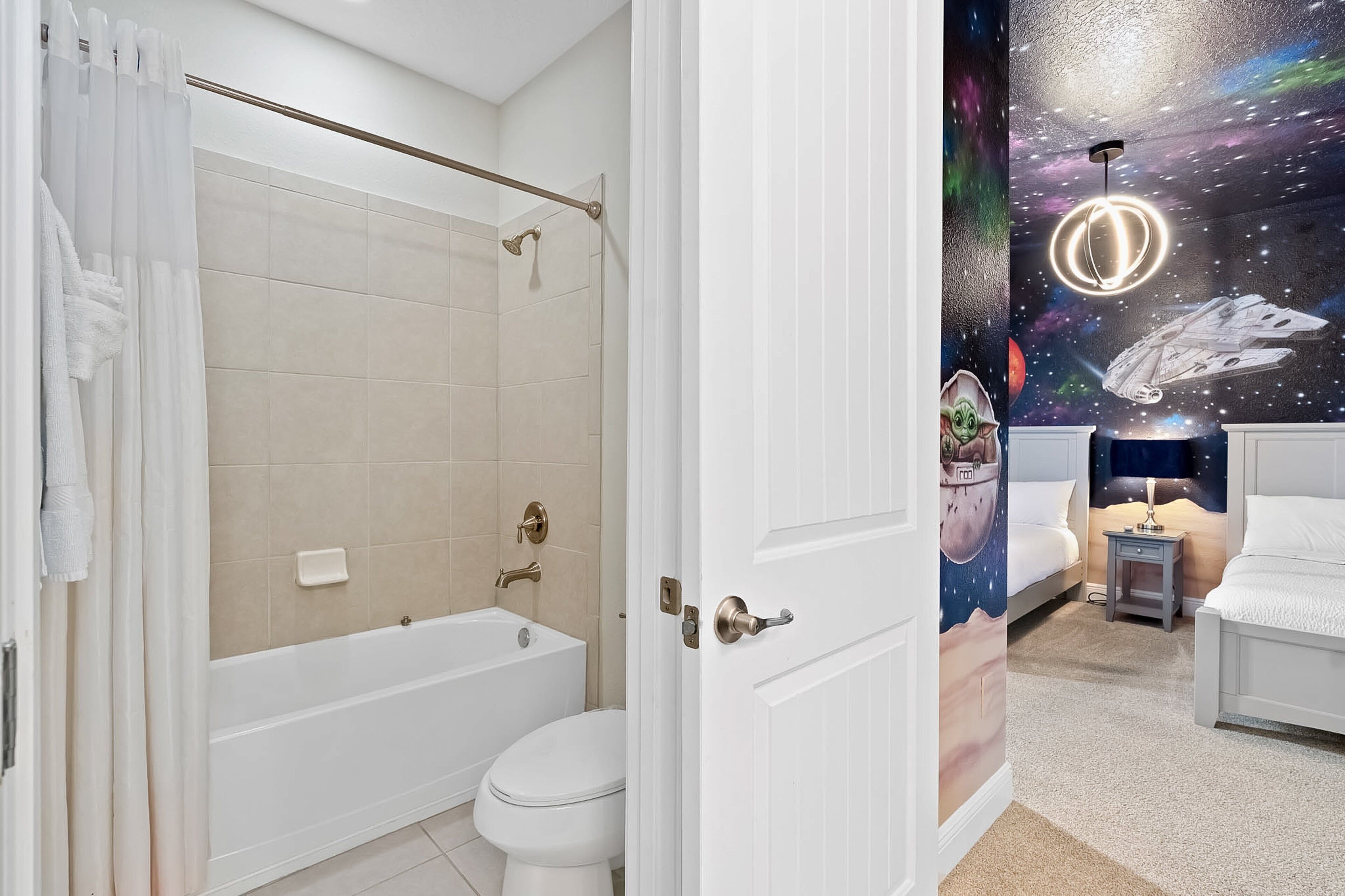 A bathroom with a bathtub, toilet, and shower.