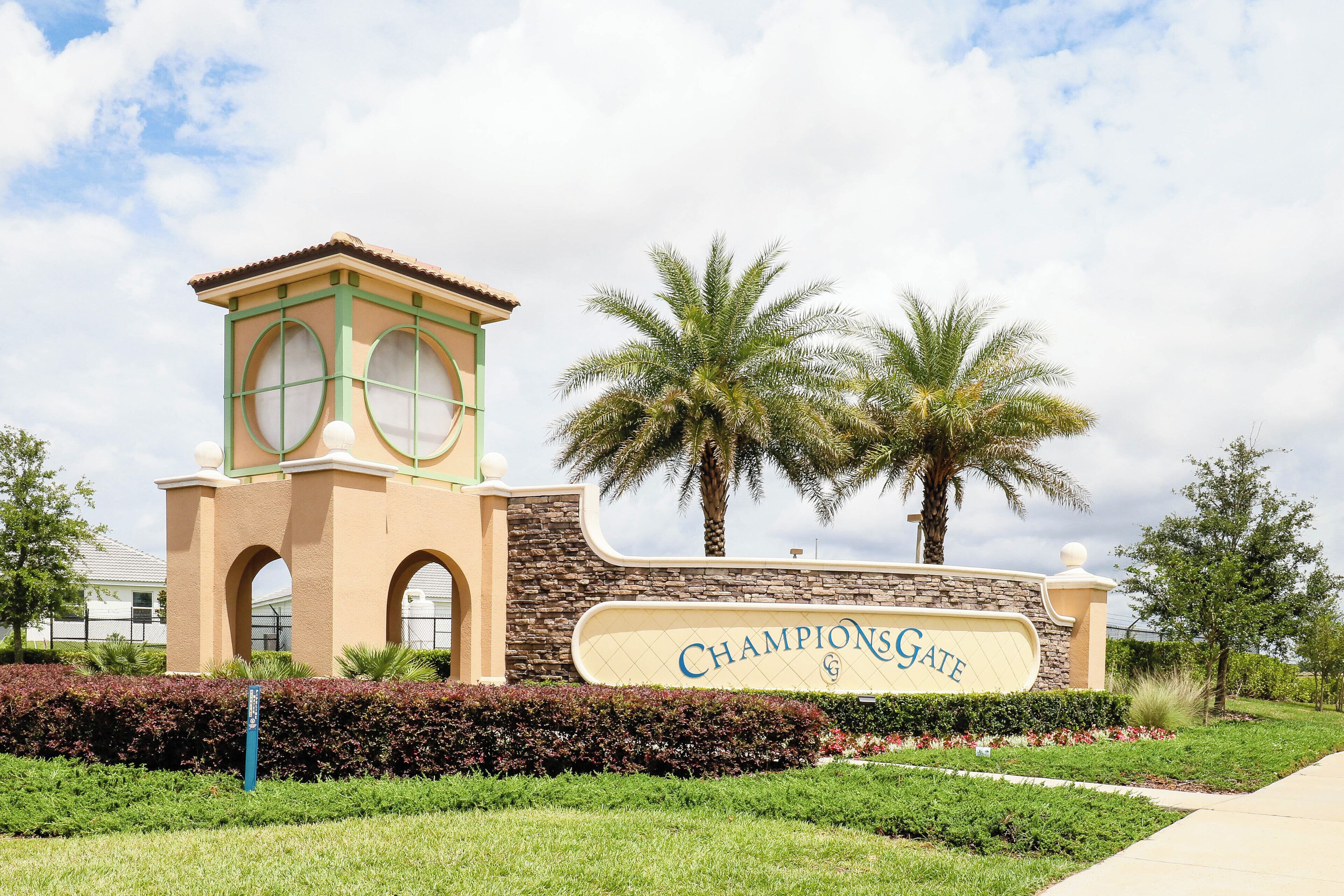 A building with a sign reading "ChampionsGate" and a tower with arched windows.