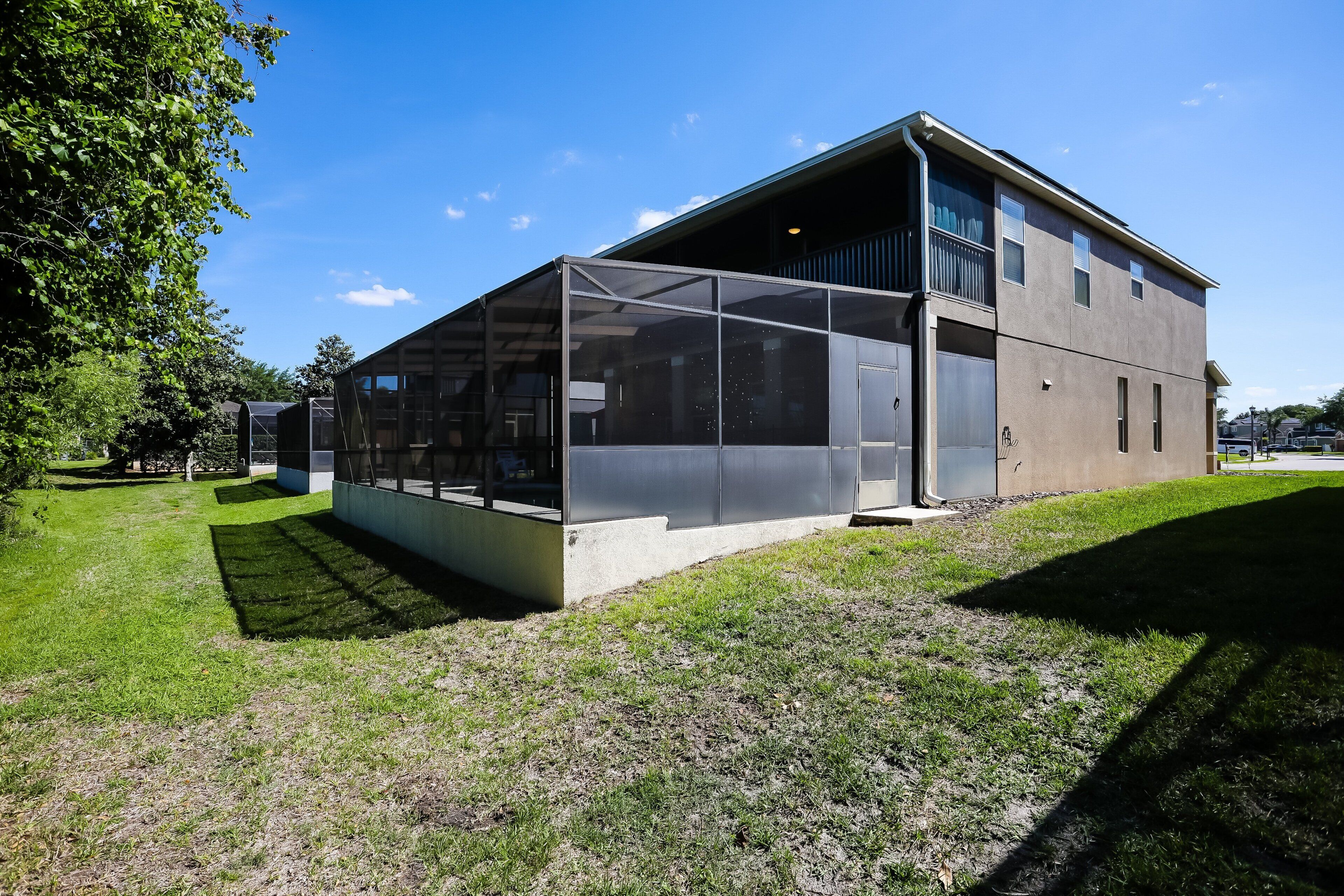 A modern building with a large glass facade, a flat roof, and a concrete base.
