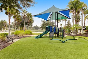 A playground with a slide, swings, and a bench. - Wonderful Home For Theme Park Fun W/private Pool, Game Room, Wifi, AC, Patio, WD (Davenport)