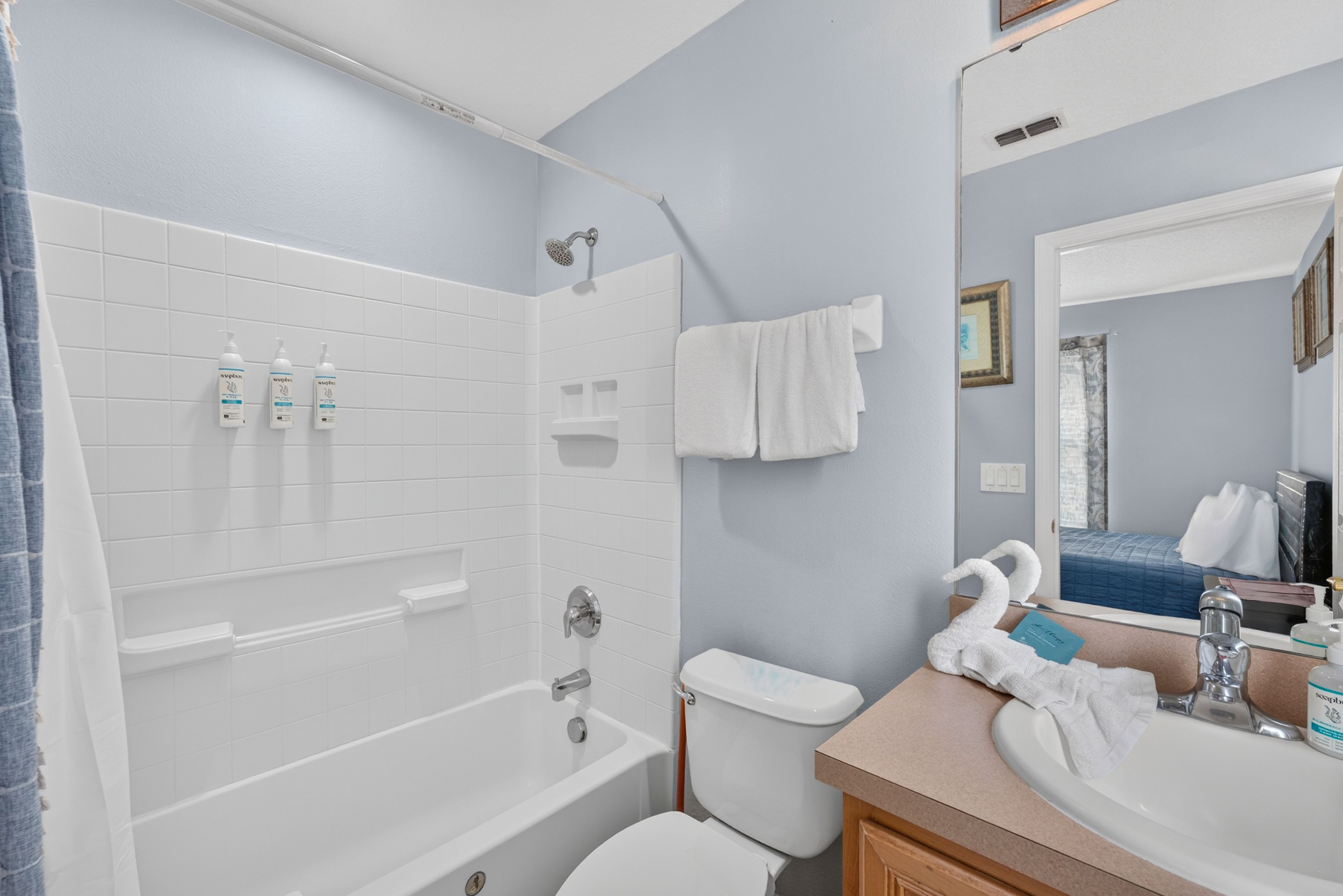 A bathroom with a bathtub, toilet, and sink.