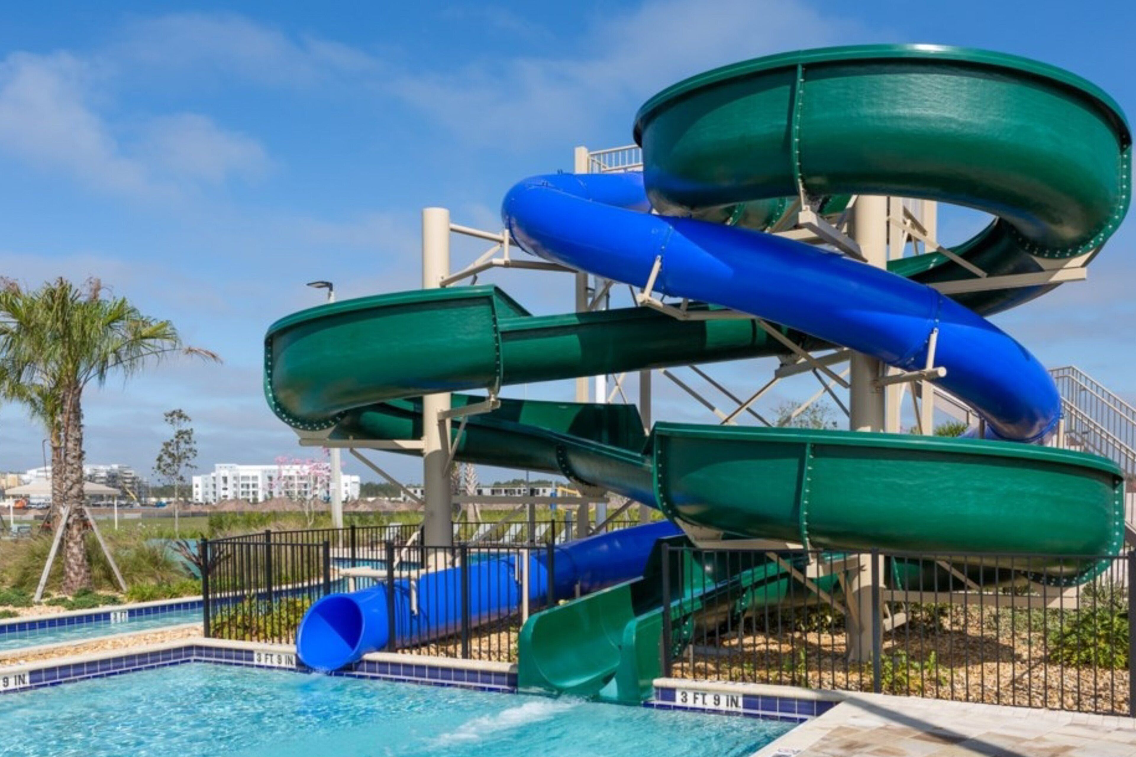 A water park with multiple slides and a pool.