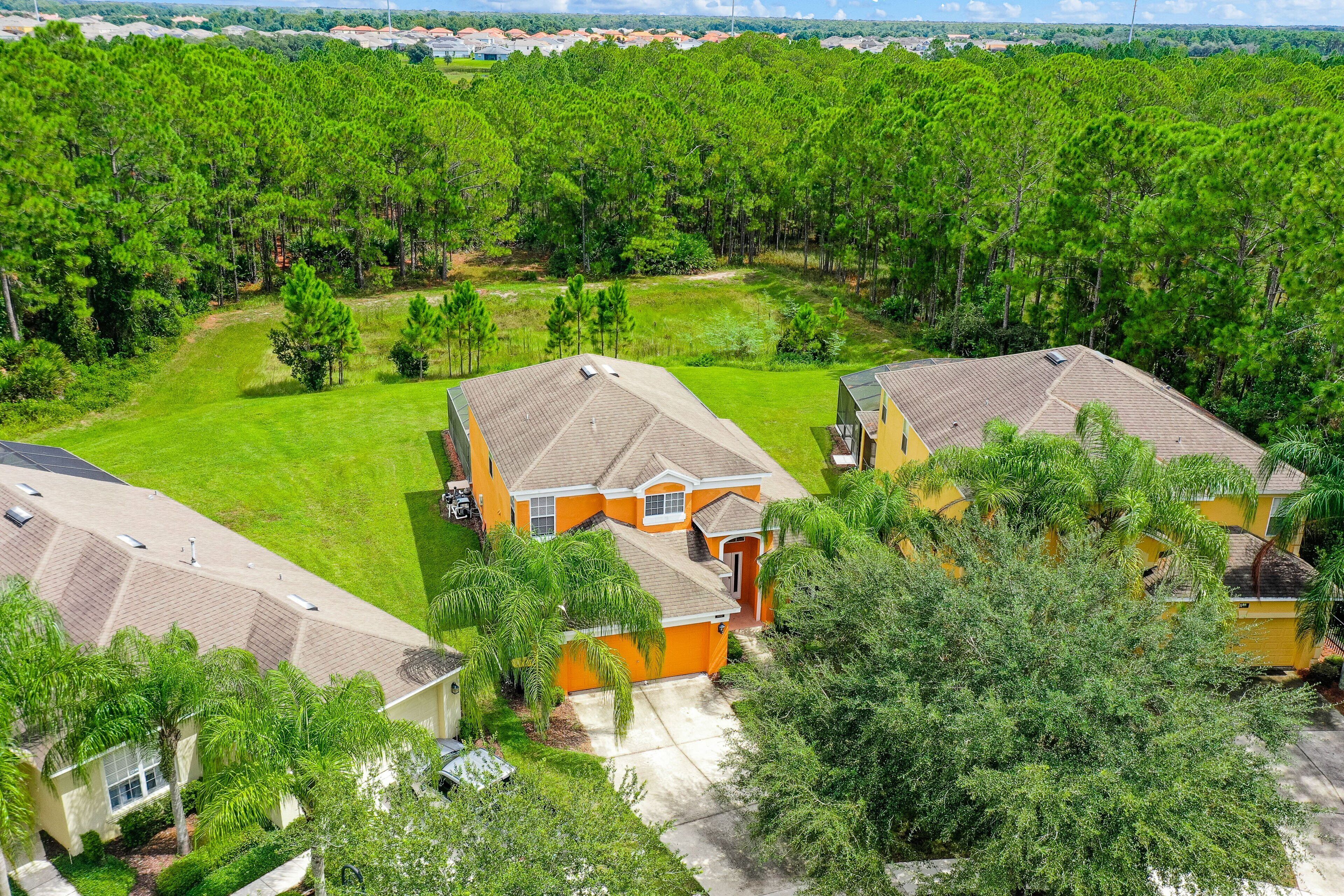 A residential area with houses, green lawns, and trees.