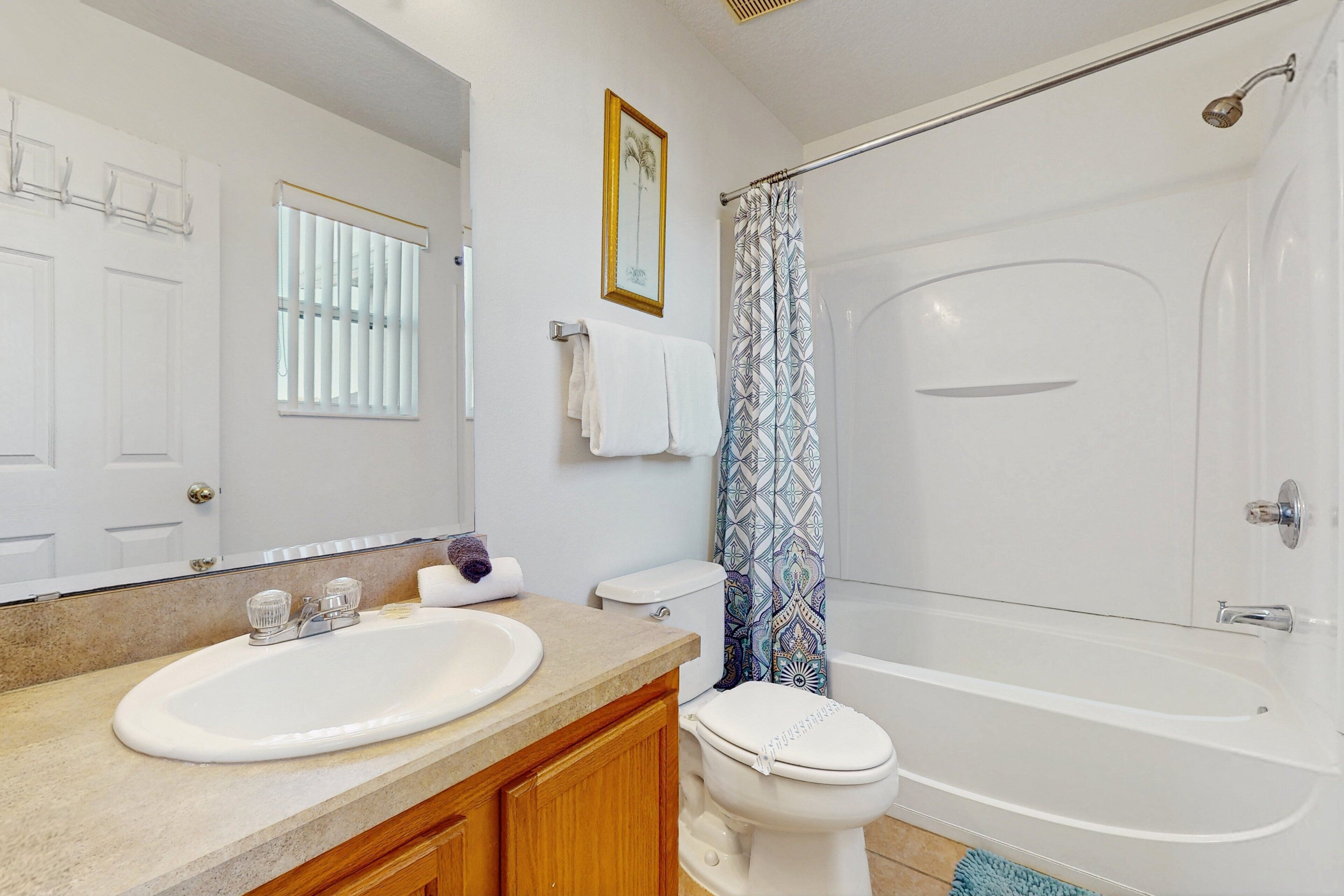 A bathroom with a sink, toilet, and bathtub.