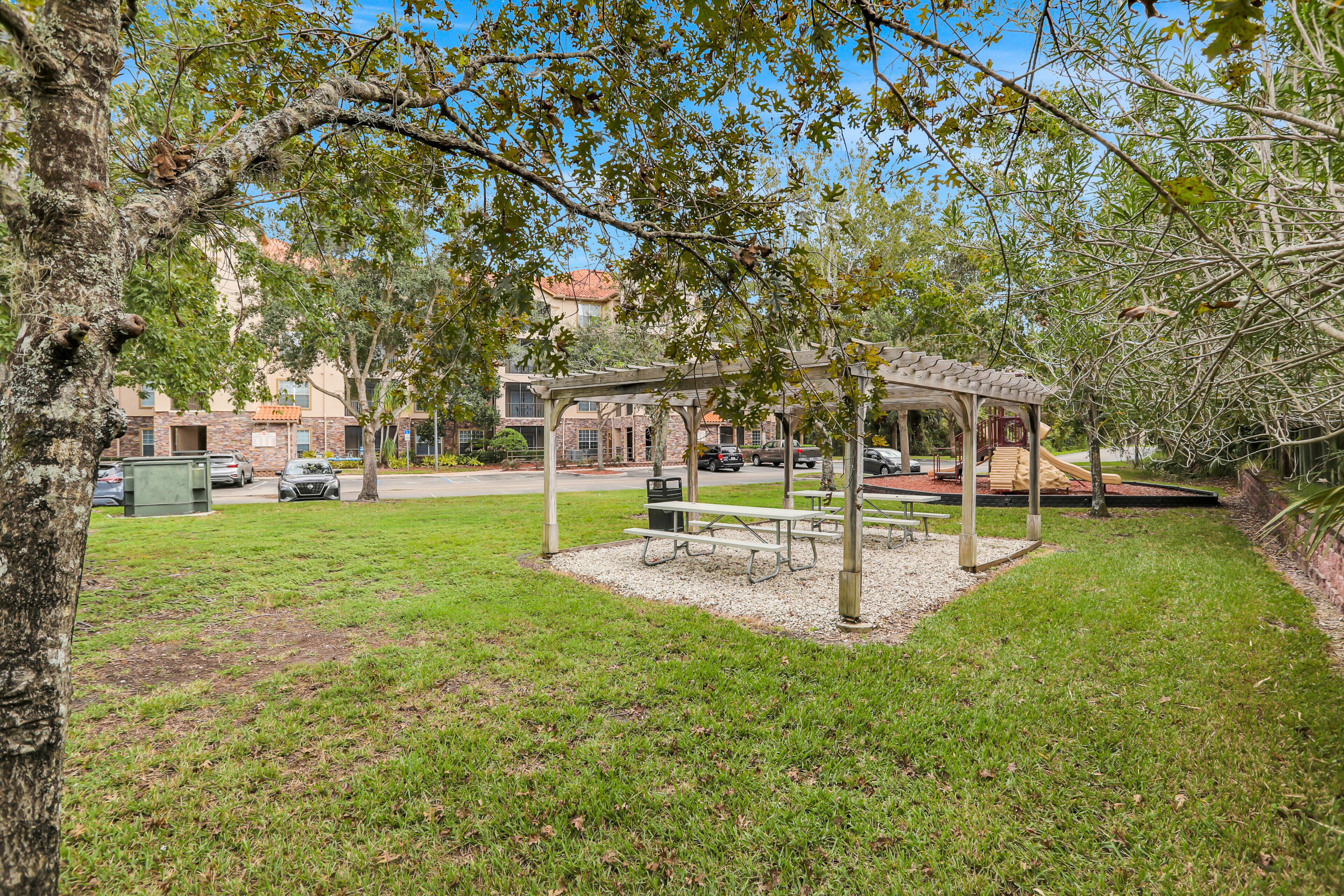 A park with a gazebo, picnic tables, and a playground.
