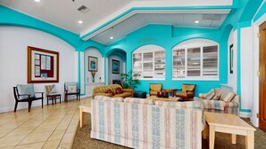 A living room with a sofa, chairs, a coffee table, and a fireplace. - Comfortable Townhome Near Disney With Athletic Courts & Pool Access, Patio, & AC (Davenport)