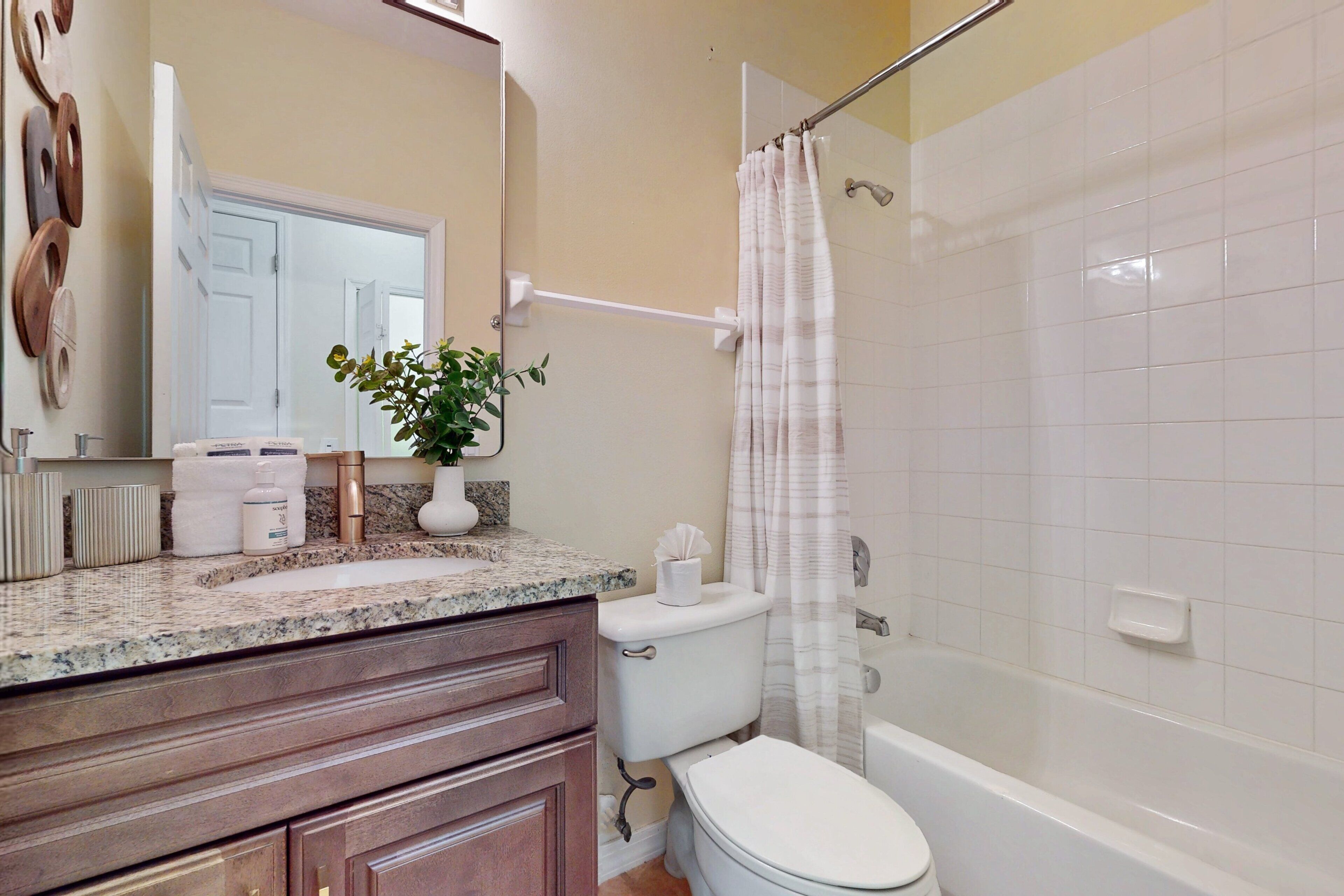 A bathroom with a toilet, sink, and bathtub.