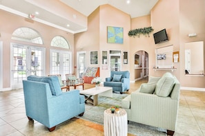 A spacious lobby with multiple seating areas, a coffee table, and a map on the wall. - Dog-friendly Home With Private Outdoor Pool, High-speed Wifi, and Central AC (Davenport)
