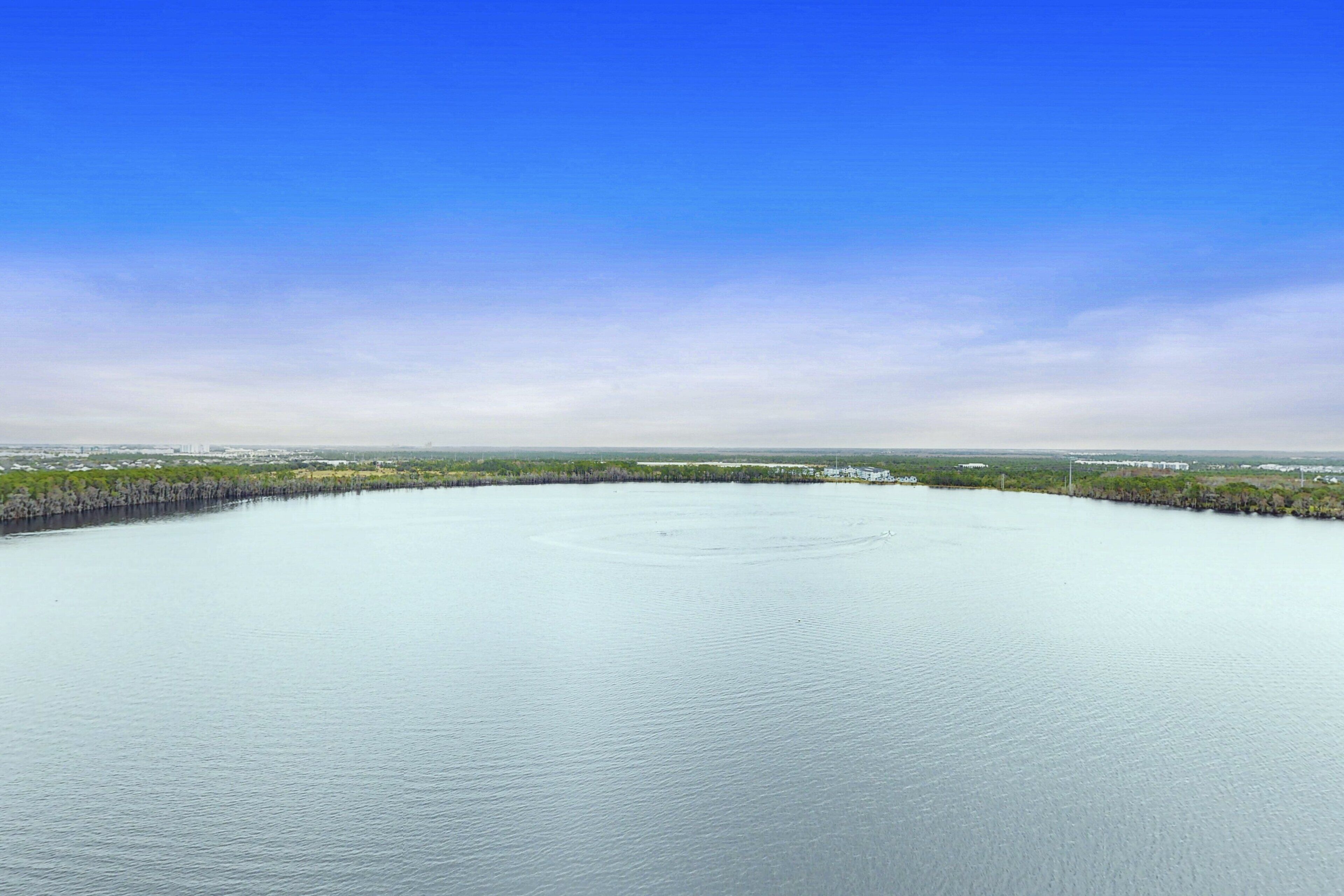 A large body of water with a clear sky above.