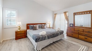 A bedroom with a bed, wooden nightstands, a dresser, a ceiling fan, and a window with curtains. - Dog-friendly Getaway With Private Pool, Tennis & AC - Near Theme Parks (Davenport)