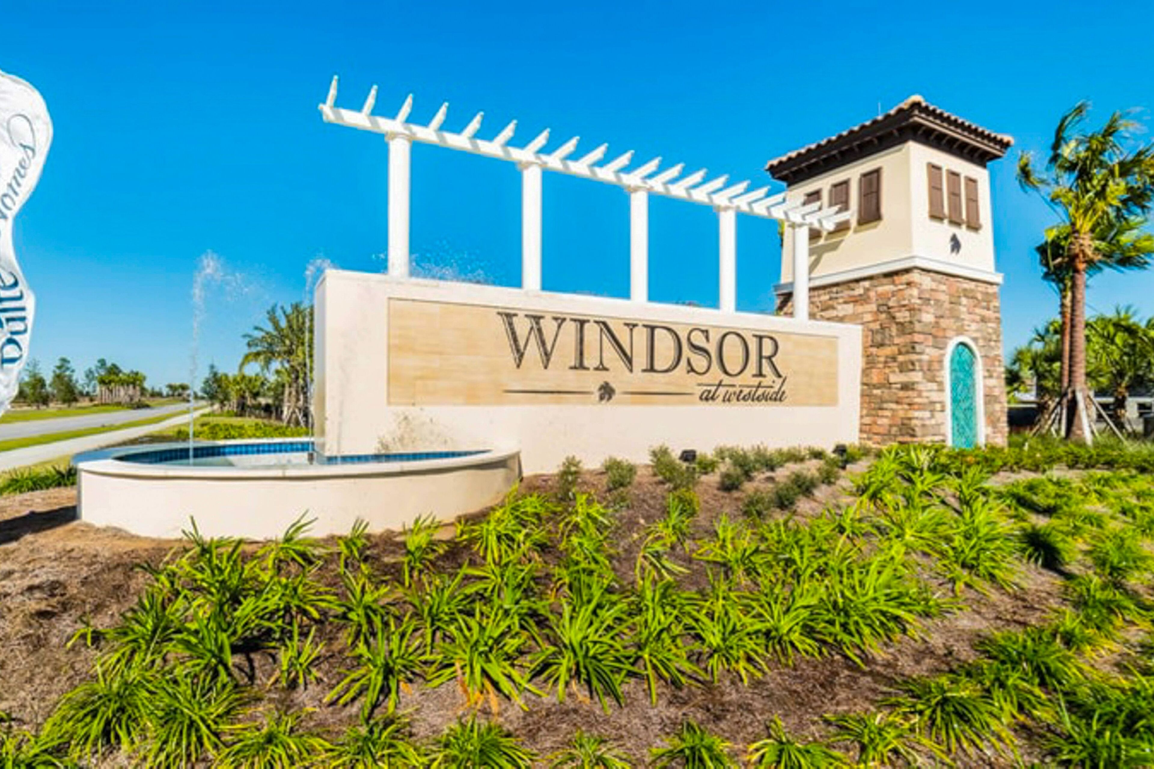 A sign for 'Windsor at the Oasis' with a pool and a pergola.
