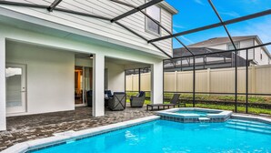 A swimming pool with a hot tub, outdoor seating, and a covered patio area. - Relax & Play Resort Villa Magical 6-bedroom Retreat Near Disney! (Davenport)
