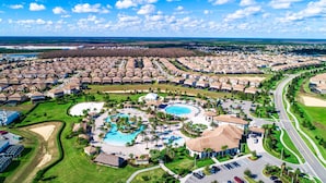 A resort with multiple bungalow-style accommodations, a central pool area, and a well-maintained landscape. - Modern Luxury Townhome With hot tub & Private Pool - Near Theme Parks (Davenport)