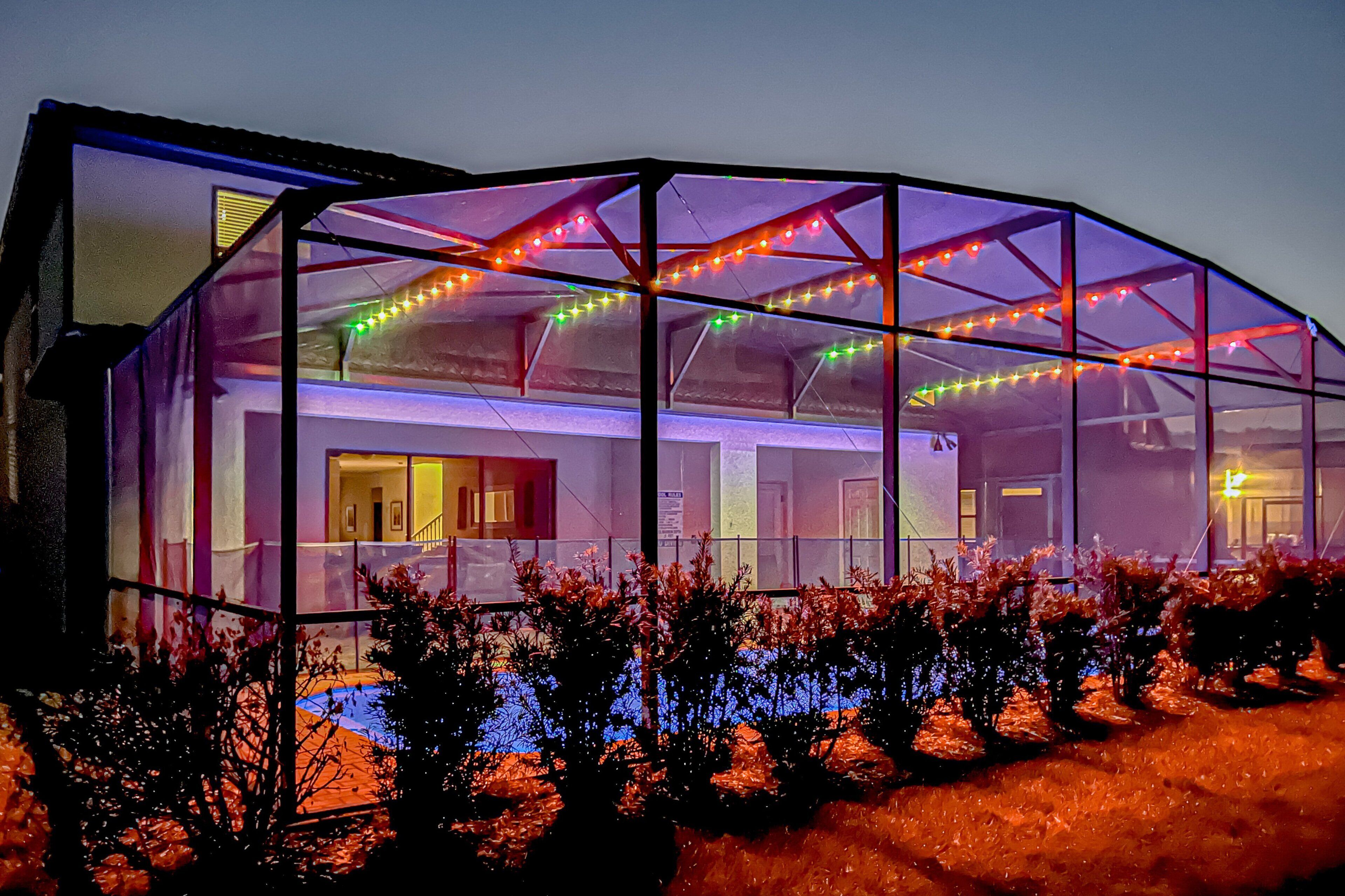 A greenhouse structure with a glass roof, surrounded by plants.