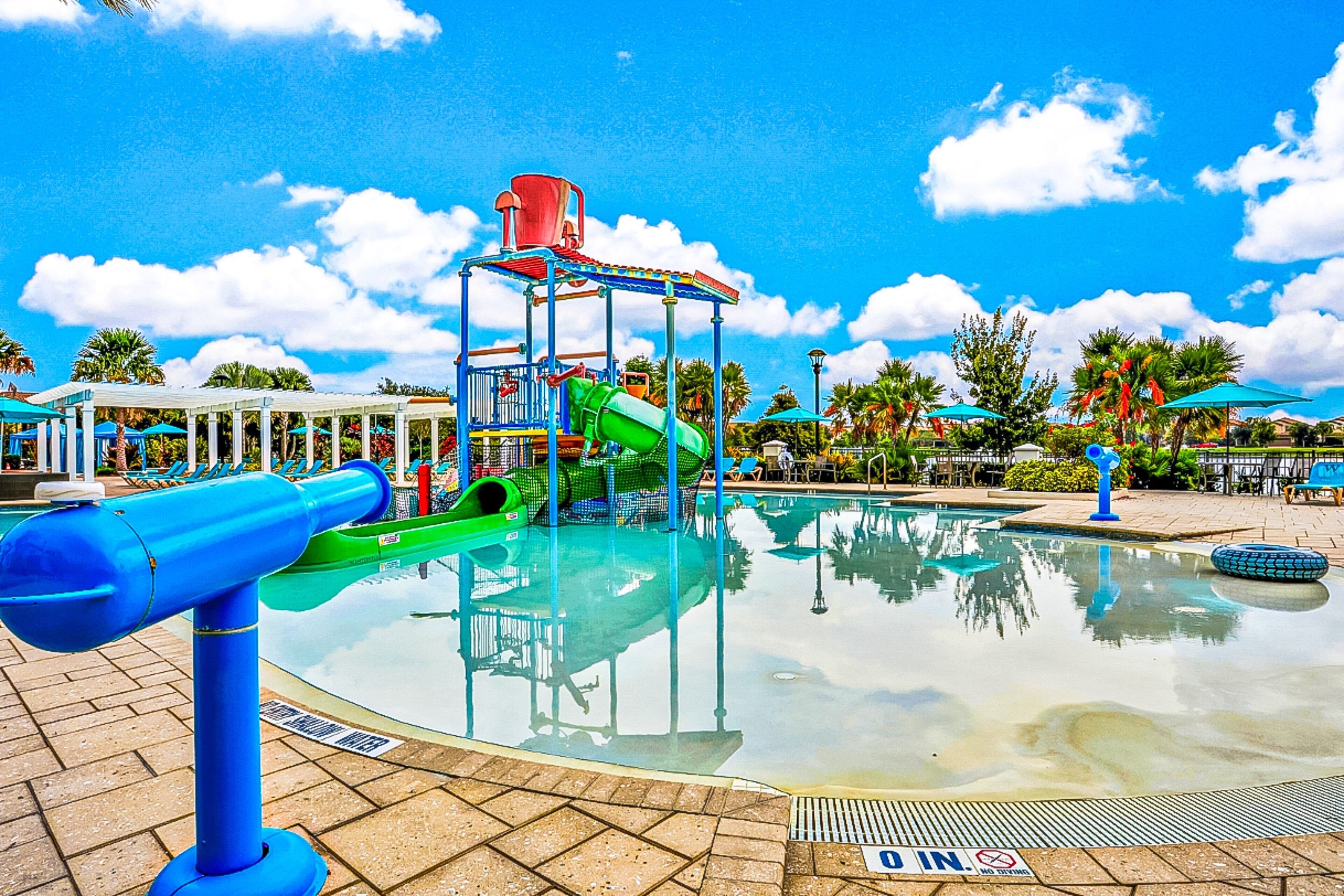 A water park with a pool, slides, and a play structure.