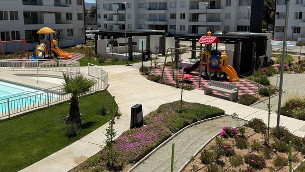 A residential building with a swimming pool, playground, and landscaped garden. - Your Perfect Getaway in La Serena! (La Serena)
