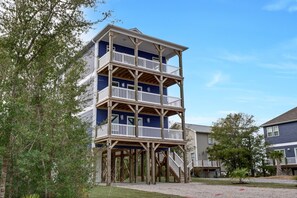 A multi-story building with a wooden deck and balconies. - Clean & Modern Home w/ 2 King Suites, Elevator, & Short Walk to Beach (Surf City)