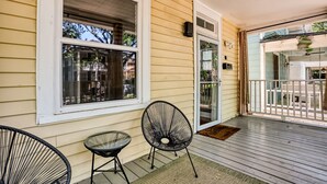 A porch with two chairs, a table, and a sliding glass door. - Near Starland, River St & DT - Gaming Arcade - Large Yard (Savannah)
