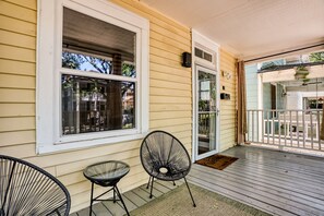 A porch with two chairs, a table, and a sliding glass door. - Near Starland, River St & DT - Gaming Arcade - Large Yard (Savannah)