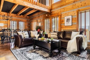 A wooden interior with a sofa, coffee table, and dining area. - Million$View,New,Hot Tub,Pool Table,Game (Seviervill)