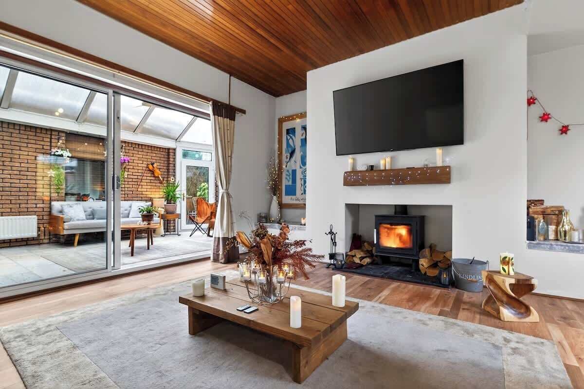 Living room with a smart tv, log burn fire and remote operated candles.