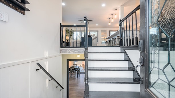 A staircase with a handrail, a ceiling fan, and a sign that reads 'blessed.' - 5BR/3BA Stylish Modern Home in Decatur (Decatur)