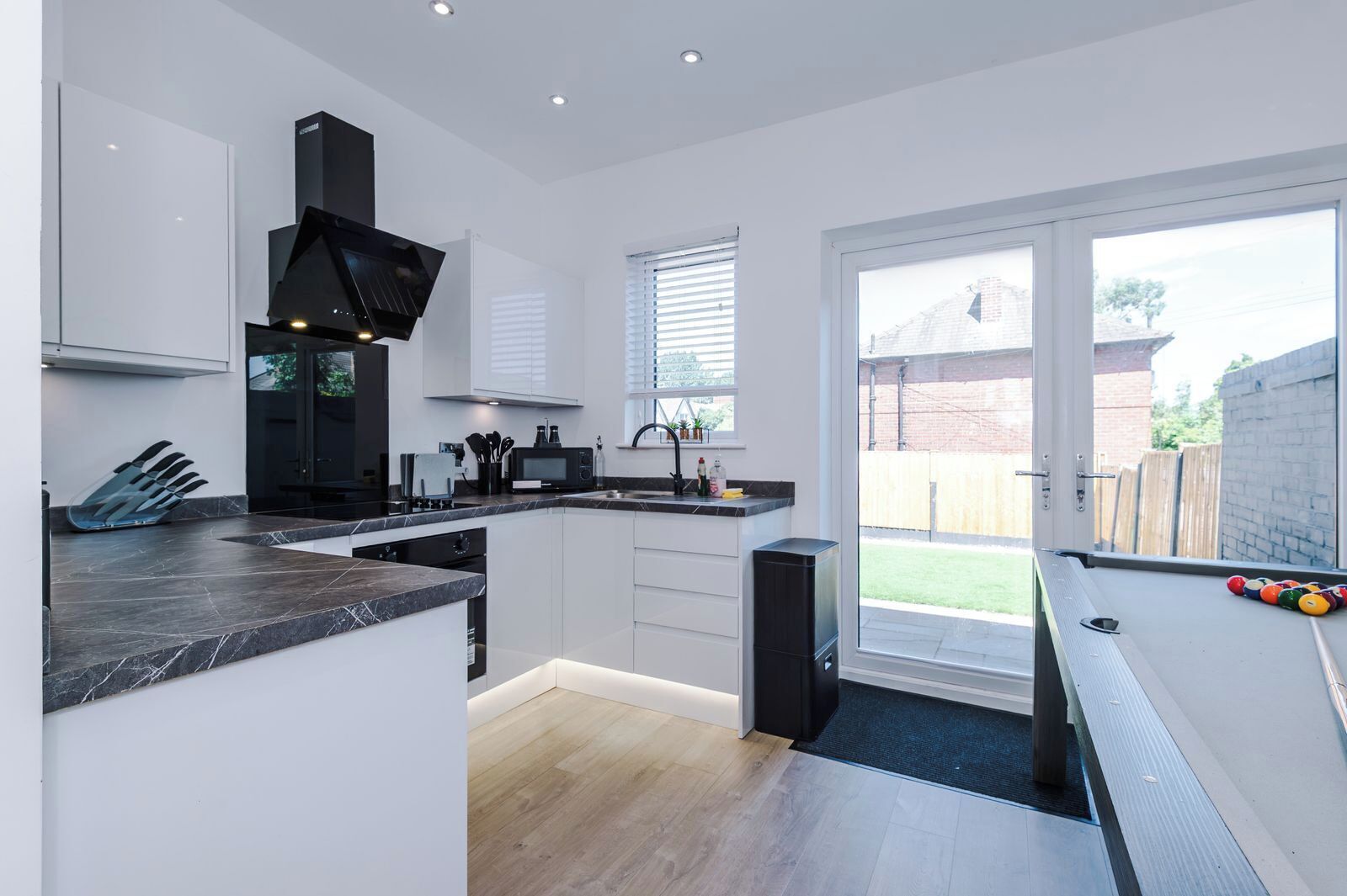 A modern kitchen with a built-in stove, microwave, and sink.