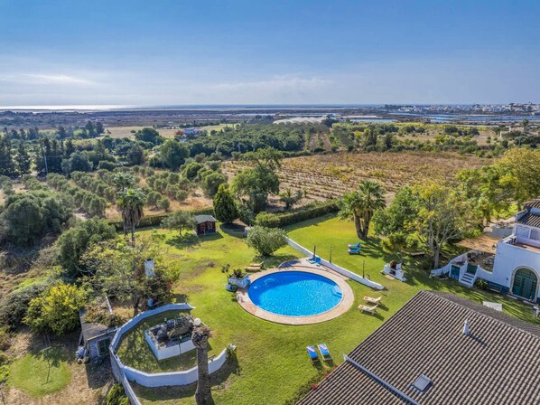 A residential property with a swimming pool, a patio area, and a view of the surrounding landscape. - Comfortable one bedroom apartment with shared swimming pool (Fuseta)