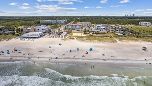 A coastal resort with beachfront accommodations, a parking area, and a view of the ocean. - Coastal Condo Oasis | Walk to Beach (Fernandina Beach)