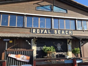 A building with a sign reading 'ROYAL BEACH' and a mural of a skull and crossbones. - Beachfront apartment with terrace - 6 guests (Calahonda)