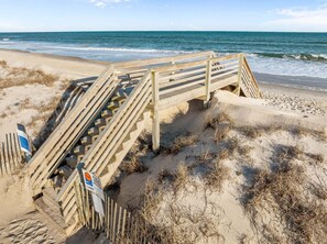 A wooden boardwalk leading to a beach with a sign indicating public water access. - TS Island - Stunning 2nd row coastal home with ocean and sound views (North Topsail Beach)