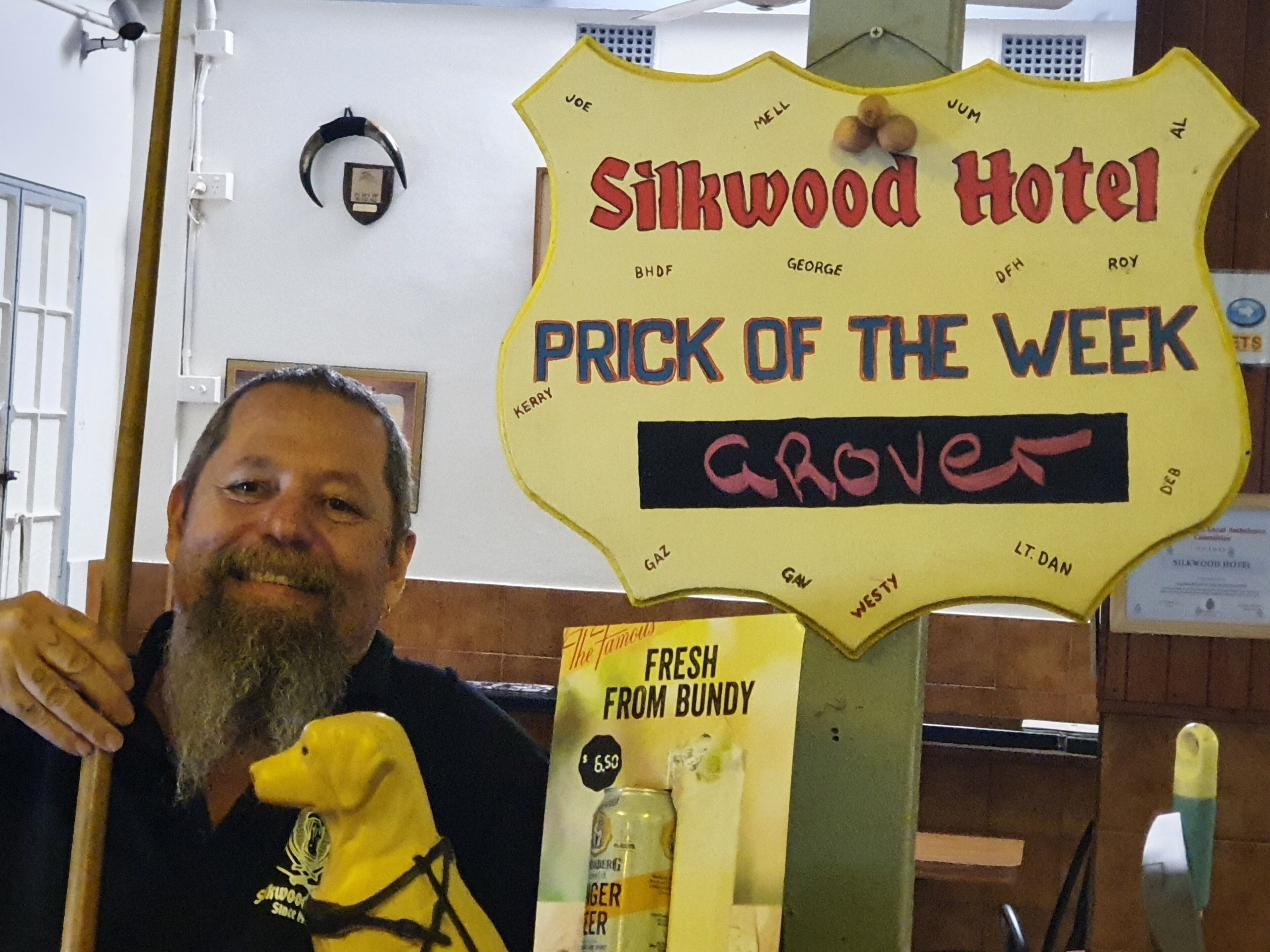 A sign for Silkwood Hotel with a 'Prick of the Week' award for Grover.