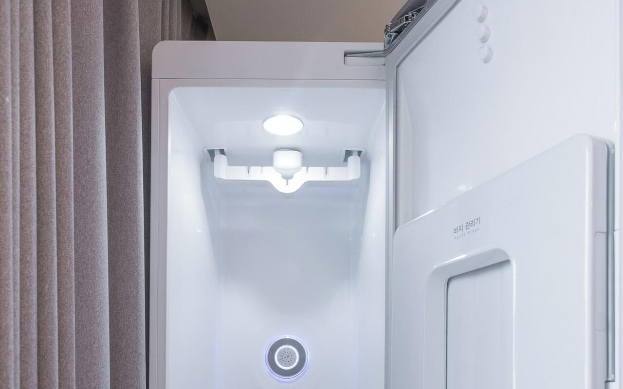 A white appliance with a control panel and a water dispenser.