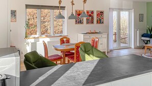 A modern kitchen with a dining area, large windows, and a view of the outdoors. - 2 bedroom awesome home in Faaborg (Faaborg)