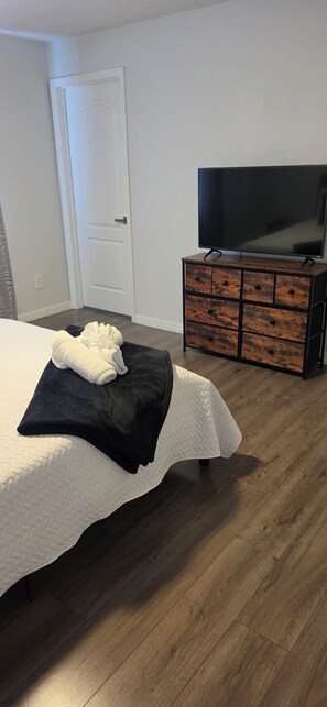 A bedroom with a bed, a dresser, and a television. - Spacious 4-bedroom house in awesome Davenport with AC (Davenport)