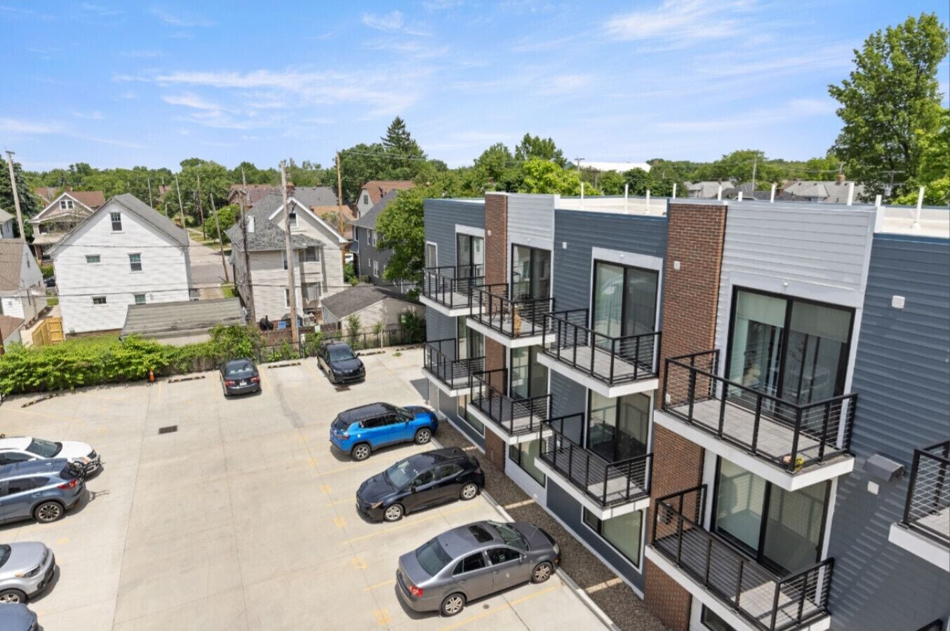 A multi-story residential building with a parking lot.