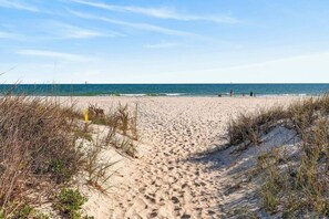A sandy beach path leading to the ocean with sparse vegetation on either side. - Sitt & Walk • New! 10 Steps to Beach • Gulf Views • Sleeps 8 (Gulf Shores)