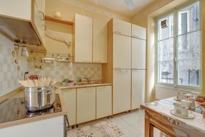 A kitchen with a sink, stove, and cabinets. - The Menton Townhouse with Balcony, Menton, France (Menton)