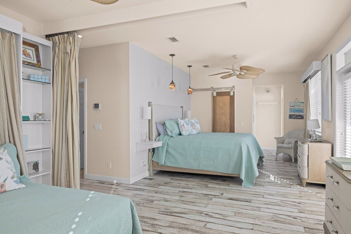 A bedroom with a bed, a wardrobe, a desk, and a chair.