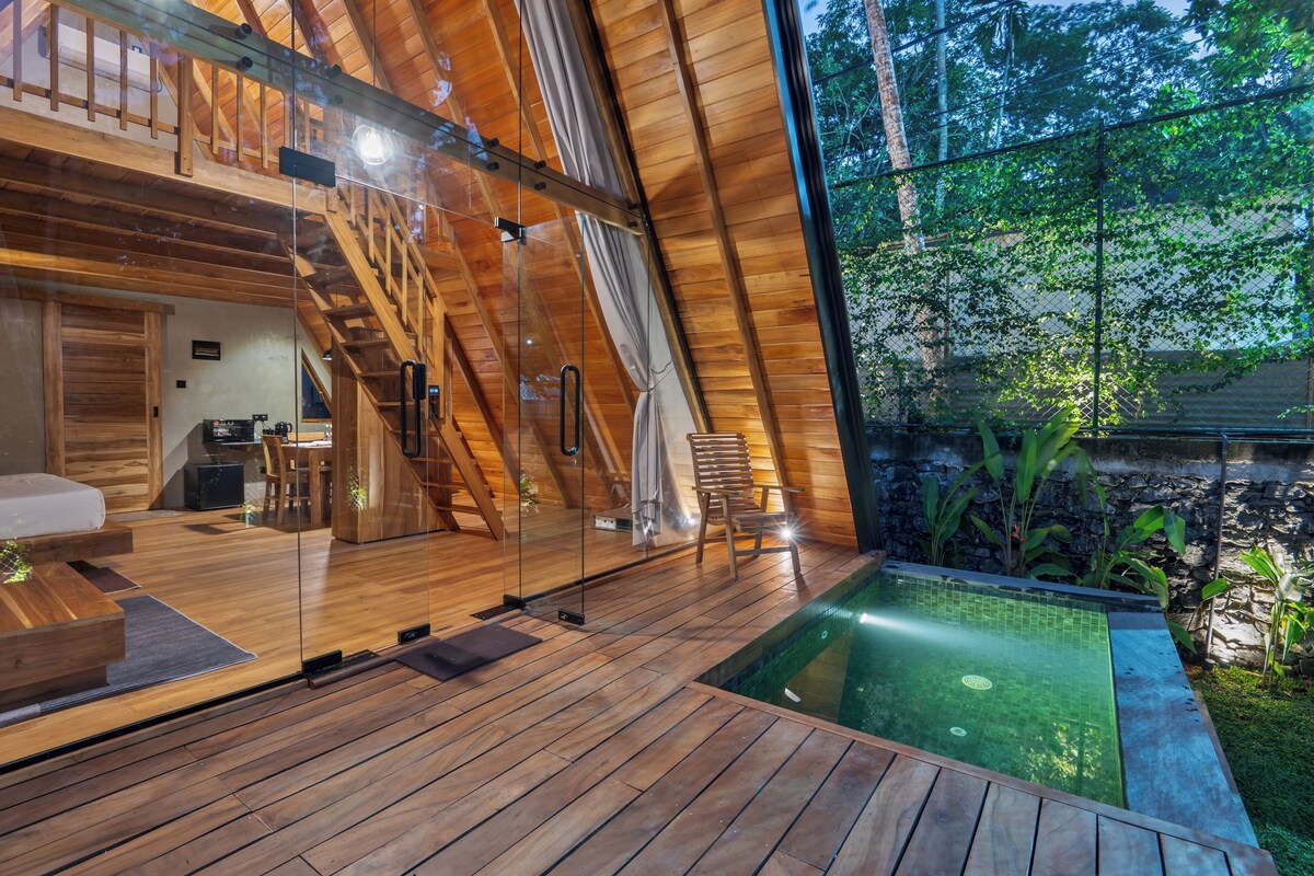 A wooden interior with a glass wall, a pool, and a staircase.