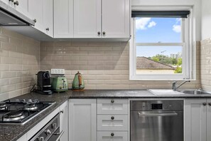 Fridge, microwave, oven, stovetop - East Melbourne Living | 1BR Near Parks & Cafes (East Melbourne)
