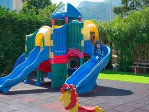 A playground with two slides, a climbing structure, and a lion-shaped toy. - Holiday apartment mit Pool (Loano)